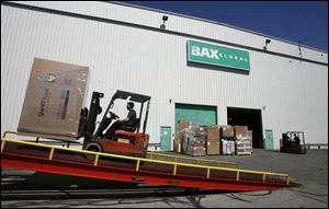 A forklift driver loads boxes onto a truck at the BAX Global hub at Toledo Express Airport in this May 16, 2008, file photo.