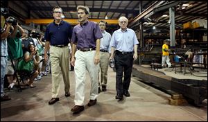 Mitt Romney, left, tours Screen Machine Industries with company President Steven Cohen. The factory makes  equipment for mining, recycling, and construction.