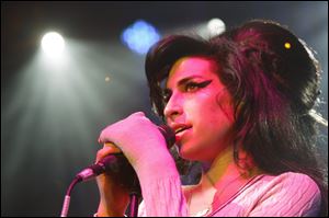 British singer Amy Winehouse performs at the Volkshaus in Zurich, Switzerland, in this Oct. 25, 2007 file photo. Winehouse was found dead July 23, 2011, by ambulance crews who were called to her home in north London's Camden area. She was 27.