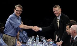 Ford Motor Company President and CEO Alan Mulally, right, shakes hands with United Auto Workers President Bob King during a news conference.