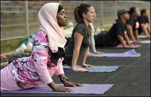 Personal trainer Mubarakah Ibrahim, left, works with clients in her early morning boot camp class in New Haven, Conn. Because of the fasting, she rearranged her schedule during Ramadan, to mostly mornings, when she has the most energy.