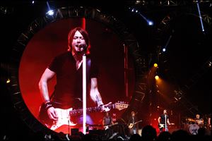 A jumbo screen projects a larger than life version of Keith Urban during his concert.
