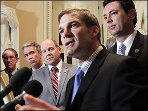 Rep. Jim Jordan, R-Ohio, the Republican Study Committee chairman, center, is surrounded by fellow House GOP members after passage of the conservative deficit reduction plan known as 