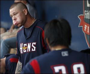 Toledo Mud Hens pitcher Ryan Perry, left, fit 55 pieces of gum into his mouth during Saturday's game.