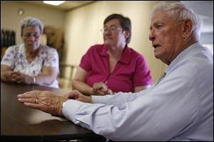 Sam Burnett, right, discusses his trip to Washington, D.C., with Linden Kuhn, left, and Cathy McVicker, at the Eleanor Kahle Senior Center in West Toledo. Mr. Burnett pitched the importance of Social Security benefits to residents here in the Toledo area.