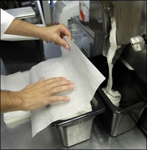 Jim Cappanari covers freshly made ice cream. He posted an apology for a recent 10-cent increase in the price of a cone.