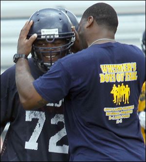 Whitmer coaches are tough on players but also encouraging. Wondell Hill congratulates a player on a good play.