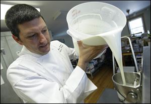 Jim Capannari, who runs a small ice-cream company in Mount Prospect, Ill., pours ingredients into a machine. He hasn't passed along much of the increases in costs of milk, butterfat, and sugar.