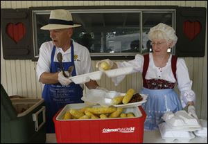 Ron and Judy Diener of Temperance, Mich., serve chicken and corn during the Teutonia Mannerchor's Kornfest.