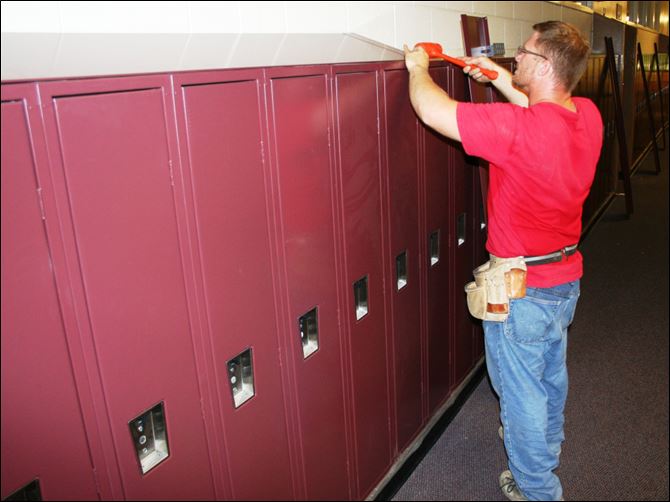 Brandon Bartson Brandon Bartson installs new lockers at Custer II Elementary School in Monroe.