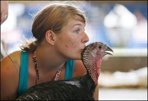 Teresa Queen, 17, kisses her turkey at the 64th annual Monroe County Fair in Monroe.