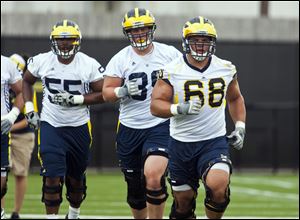Michigan's Jibreel Black, left, Will Heininger, and Mike Martin will be on the move on defense.