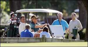 U.S. House Speaker John Boehner, seated at left, golfed with U.S. Rep. Bob Latta (R., Bowling Green), second from right, at the start of Mr. Latta's re-election campaign fund-raiser at the Inverness Club. Particpants paid $1,000 to $10,000 to be part of the event.