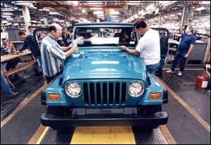 1996: Ken Wieland and Dave Pixley put the finishing touches on the first Wrangler TJ to come off the line at the Stickney Avenue Jeep plant.