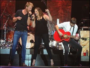Charles Kelly, Hillary Scott, and Dave Haywood  of Lady Antebellum perform at Country Thunder music festival in Twin Lakes, Wis. in July.