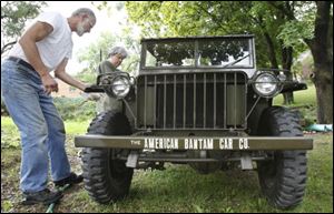 Larry Collins, left and his wife, Pat Collins wipe down a Bantam reconnaissance car outside their home in Butler, Pa. The inaugural Bantam Jeep Heritage Festival, which runs from Friday through Sunday, is to feature a parade of more than 1,200 Jeeps; a playground where aficionados can drive over rocky obstacles, hills, and bridges, and fair-like entertainment and eats. But, most importantly, it shines a spotlight on Butler and the defunct American Bantam Car Co. which has made the city of nearly 14,000 residents almost famous.