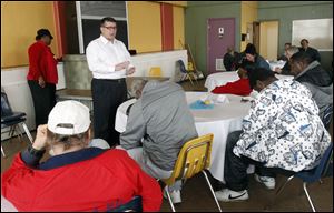 Dan Rogers, president and chief executive officer of Cherry Street Mission Ministries, leads a prayer during Easter dinner.
