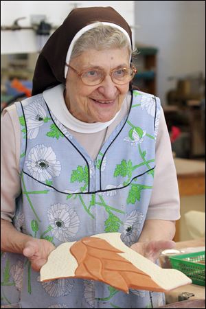 Sister Jane Mary Sorosiak shows part of her mural. Some of her art is for sale at All Good Things shop at Sylvania’s Lourdes College.