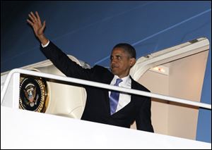 President Barack Obama waves as he boards Air Force One at John F. Kennedy International Airport in New York en route to Washington earlier this week.