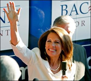 Michele Bachmann waves to supporters from her campaign bus after being named the winner of the straw poll.