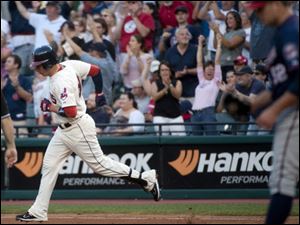 Cleveland Indians batter Asdurbal Cabrera, left, rounds first base on his three-run home run off Minnesota Twins pitcher Brian Duensing, right, during the third inning Saturday.