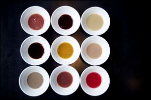 A variety of ketchups at Jose Andres’ restaurant, America Eats Tavern. Left to right top row, blueberry, blackberry, oyster; left to right middle row, mushroom, yellow tomato, gooseberry; left to right
bottom row, anchovies, spice berry and red currant.