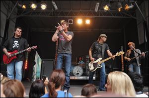 From left, guitarist Chris Henderson, vocalist Brad Arnold, bassist Greg Upchurch, and guitarist Matt Roberts of Three Doors Down perform.