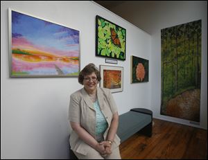 Jeannine Dailey, a disabled artist starting a custom mural business with the help of a project funded by the American Reinvestment and Recovery Act, displays her art at Shared Lives Studios and Gallery in Toledo.
