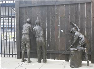 One of the four figures from the 'Who's Up?' sculpture at Fifth Third Field downtown was reported missing Sunday night. The little girl in pigtails was gone from the statue behind the scoreboard.  