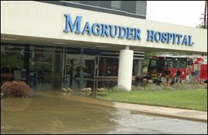 Port Clinton firefighters examine water damage to H. B. Magruder Hospital, which  transferred three patients to other hospitals and discharged three.