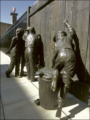The statue, incorporated into the fence around Fifth Third Field, was created by local artist Emanuel
Enriquez and installed in 2002. In the early morning
hours of Saturday, two Toledo police officers found part of the statue, a little girl in pigtails, about 20 yards from its original location. The officers booked the statue into the property room for safekeeping,
but apparently nobody informed Mud Hens officials
or the Arts Commission of Greater Toledo.