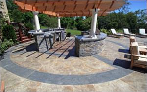 Concrete patios, like this one by New England Hardscapes Inc., can turn your backyard into a beautiful sanctuary.