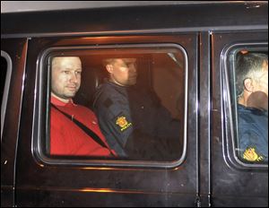 Norway's twin terror attacks suspect Anders Behring Breivik, left, sits in an armored police vehicle after leaving the courthouse following a hearing in Oslo in July.