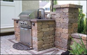 Solid retaining wall units can be easily cut to fit a grill or refrigerator and topped with a nice stone slab.