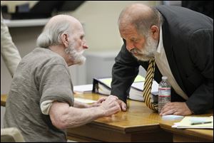 Robert Bowman confers with attorney Pete Rost  during his trial in Lucas County Common Pleas Court, Friday, August 19, 2011.  He is accused of killing of 14-year-old Eileen Adams in 1967.  Bowman decided not to testify and the defense rested on Friday.