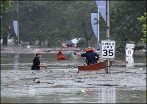 Pittsburgh emergency responders throw a life vest to Robert Bailey, 80, who climbed onto the roof of his car after being caught in a flash flood, Friday in Pittsburgh. 