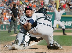 Cleveland’s Kosuke Fukudome is tagged out by Detroit catcher Alex Avila on a throw from center fielder Austin Jackson to end the game.