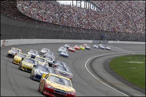 Kurt Busch leads the field at MIS near the middle of Monday's race, which was attended by 81,000 fans.
