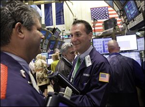 Trader Jonathan Corpina has a smile at the New York Stock Exchange on a day indexes made small gains. A Federal Reserve report said sales by baby boomers could be a long-term depressant for stock prices.