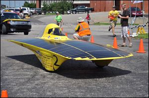 The futuristic 500-pound, street-legal car and members of the University of Michigan Solar Car Team will visit Owens Community College Thursday from 3 to 8 p.m. The car will be on display outside the Industrial and Engineering Technologies building.