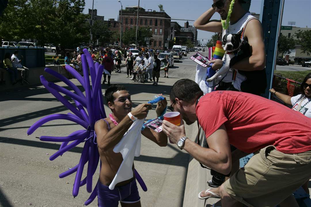 Gay-pride-parade-marcher-gives-crowd-member-a-lei
