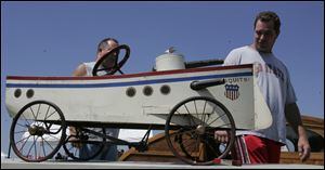 Pat Waldvogel, left, and his brother, Joe, look over a 1915 Mosquito gunboat on display during the fifth annual Toledo Antique & Classic Boat Show at the Toledo Maritime Center in East Toledo.