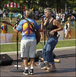 The local band No Excuses, a folk and pop group featuring members Lisa Binkowski, left, and Merri Bame, was one of the musical groups to perform during the second annual Toledo Pride event at Promenade Park.