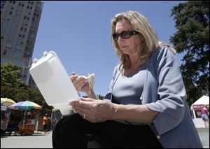 In this July 20 photo, D'Anne Ousley has lunch out of a plastic foam container in Sacramento. A measure by state Sen. Alan Lowenthal ( D., Long Beach) if approved by the legislature and signed by Gov. Jerry Brown, would prohibit restaurants, grocery stores and other venders from dispensing food in expanded polystyrene containers, commonly known as Styrofoam, beginning in 2016. 
