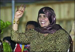 Safiya Gadhafi, the wife of Libyan leader Moammar Gadhafi, seen here in 2003, fled to Algeria Monday.