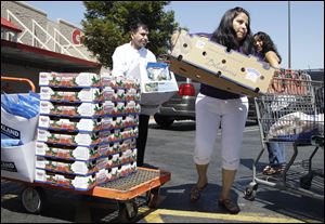 Shoppers unload their items at Costco in Mountain View, Calif.