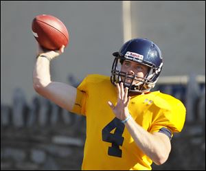 University of Toledo quarterback Austin Dantin (4) throws a pass during football practice at the Glass Bowl in Toledo, Wednesday, Aug. 10.