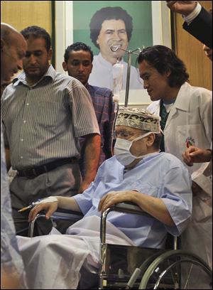 In this Sept. 9, 2009 file photo, Libyan Abdel Baset al-Megrahi, who was found guilty of the 1988 Lockerbie bombing is seen below a portrait of Libyan Leader Moammar Gadhafi.
