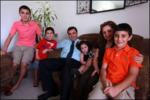 In a Monday, Aug. 8, 2011 photo, Doctor Labeed Nouri, 40, and his wife Rouwaida Nouri, 38, with their children Hakam, 15, left, Jacob,7, Maria,4, and Sami,12, in their Sterling Heights home. Nouri, an orthopedic surgeon, went to prison for three years after an office aide he hired just four days before accused him of sexually assaulting her. She was later caught on tape admitting she liedon the stand. Nouri has regained his medical license.