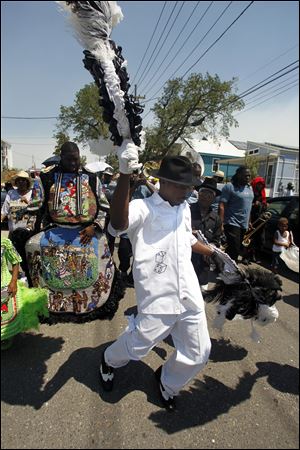 A member of the Big 9 marching club dances in a second line event commemorating the sixth anniversary of Hurricane Katrina in New Orleans, Monday, Aug. 29, 2011.